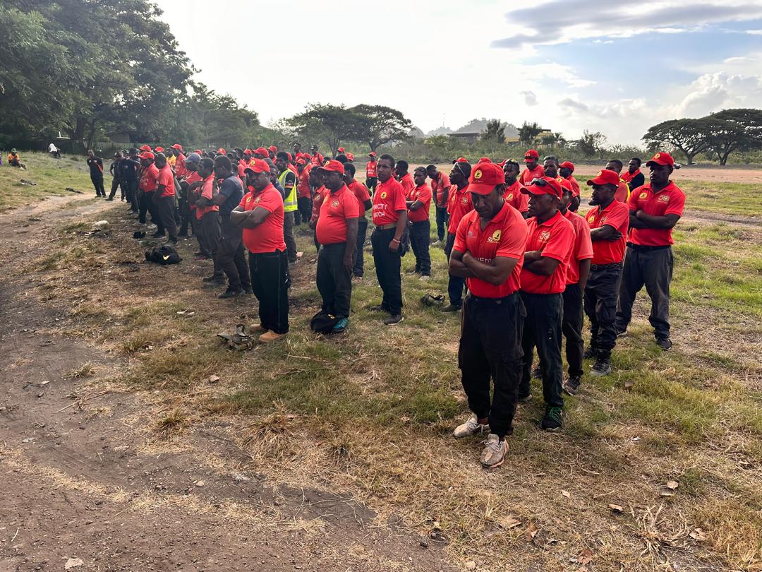 POM CITY WATCH personnel in red uniforms in Port Moresby